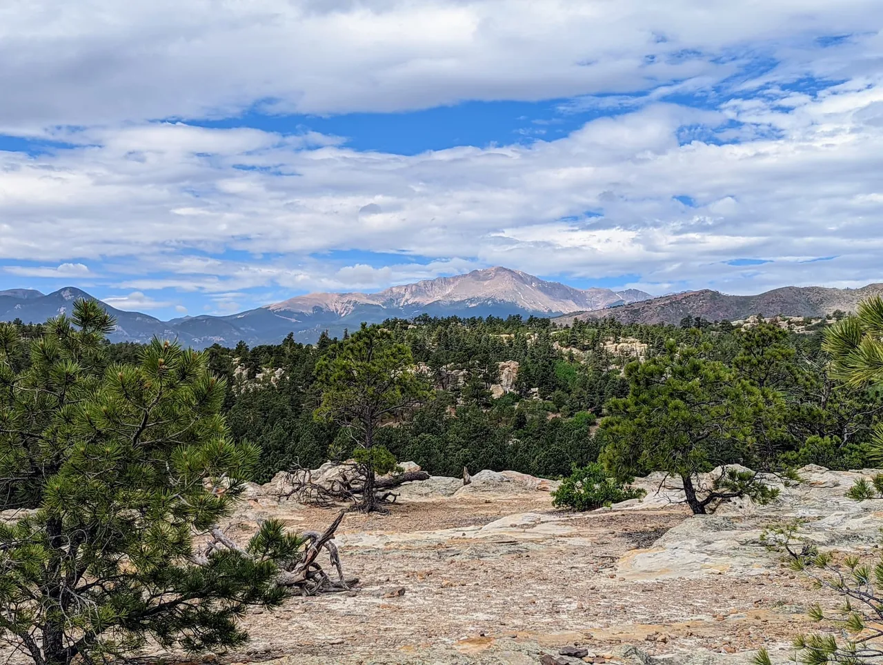 Ute Valley Park sandstone, pines, and Pikes Peak under an open sky